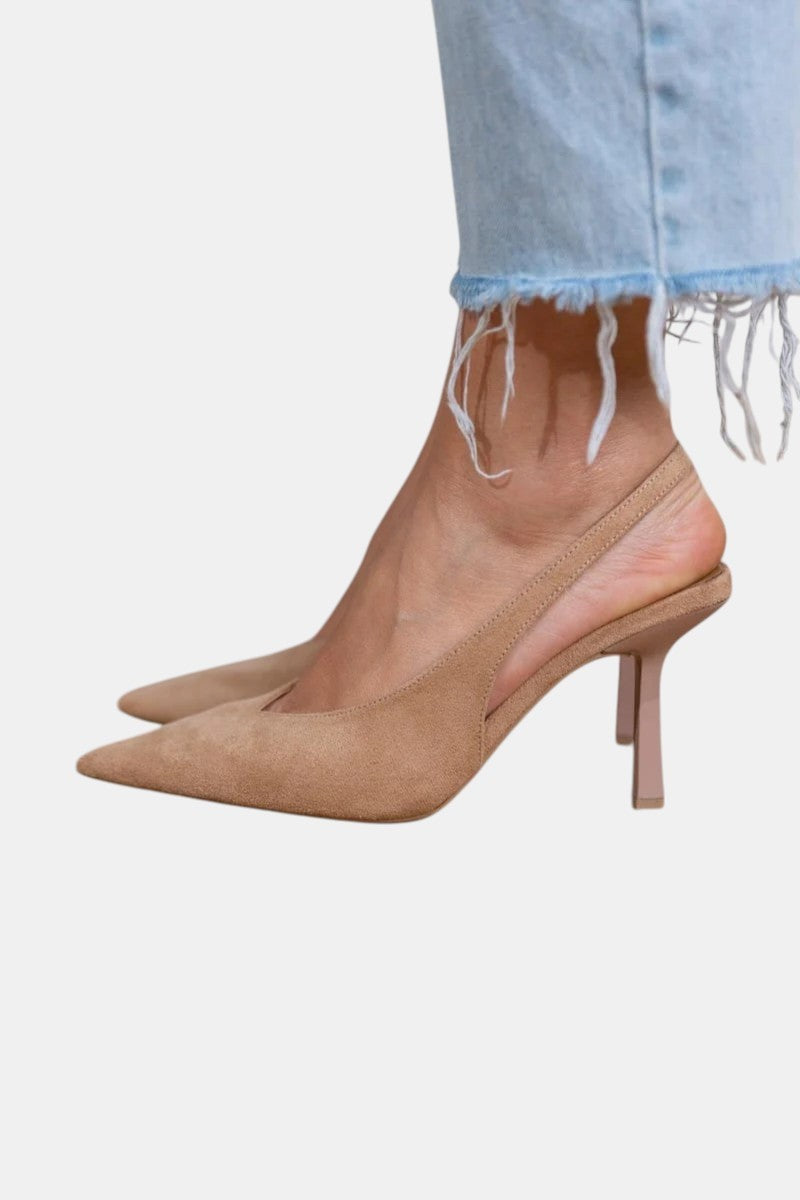 Tan suede pointed toe slingback heels paired with frayed denim jeans