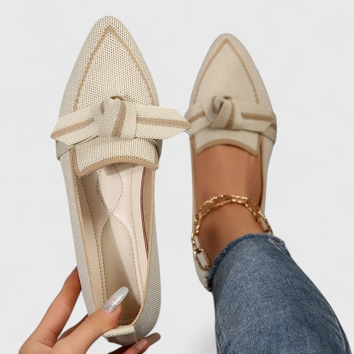 Beige knit pointed-toe loafers with gold trim and bow accent