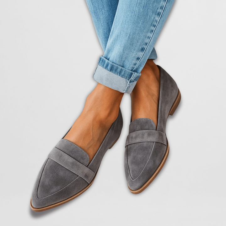 Gray suede pointed-toe loafers paired with cuffed light-wash denim, flat sole