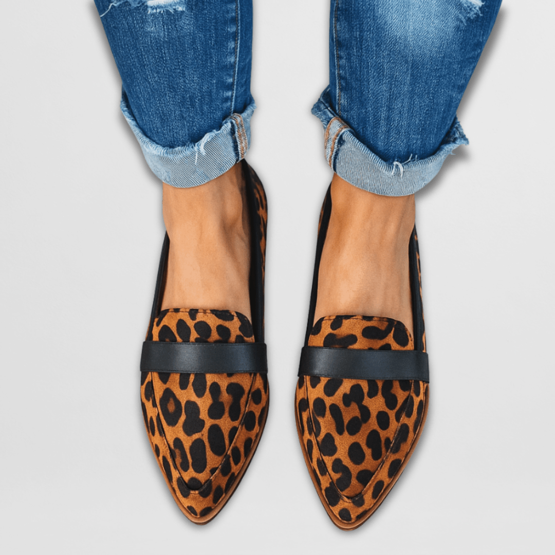 Leopard print pointed-toe loafers with black penny strap, worn with cuffed jeans