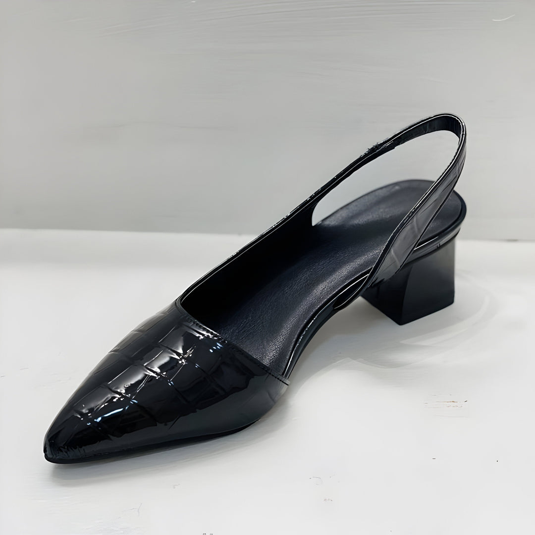 black patent slingback pump showing block heel and pointed toe design