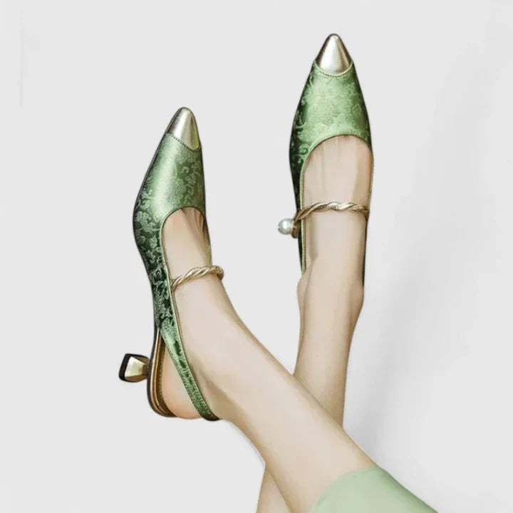 Pointed-toe green satin heels featuring twisted gold strap and pearl detail