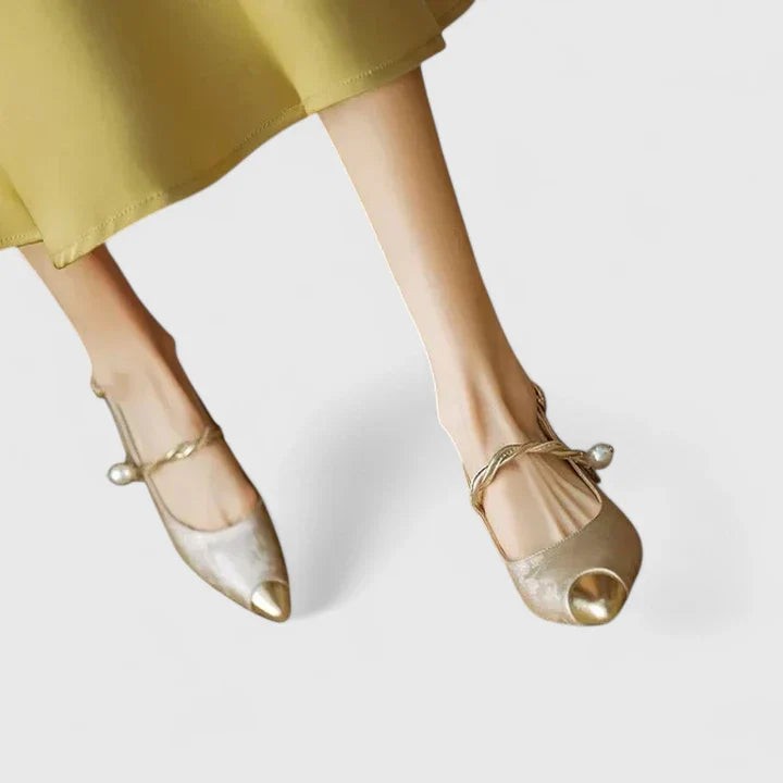 Metallic gold slingback heels with pearl accent and pointed toe design