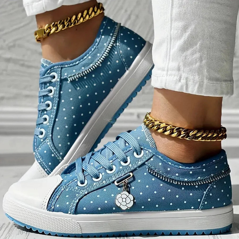 White toe cap sneakers with navy polka dots and floral lace panel