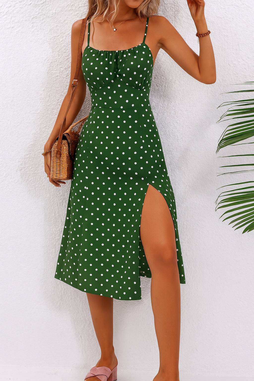 Green polka dot midi dress paired with woven crossbody bag