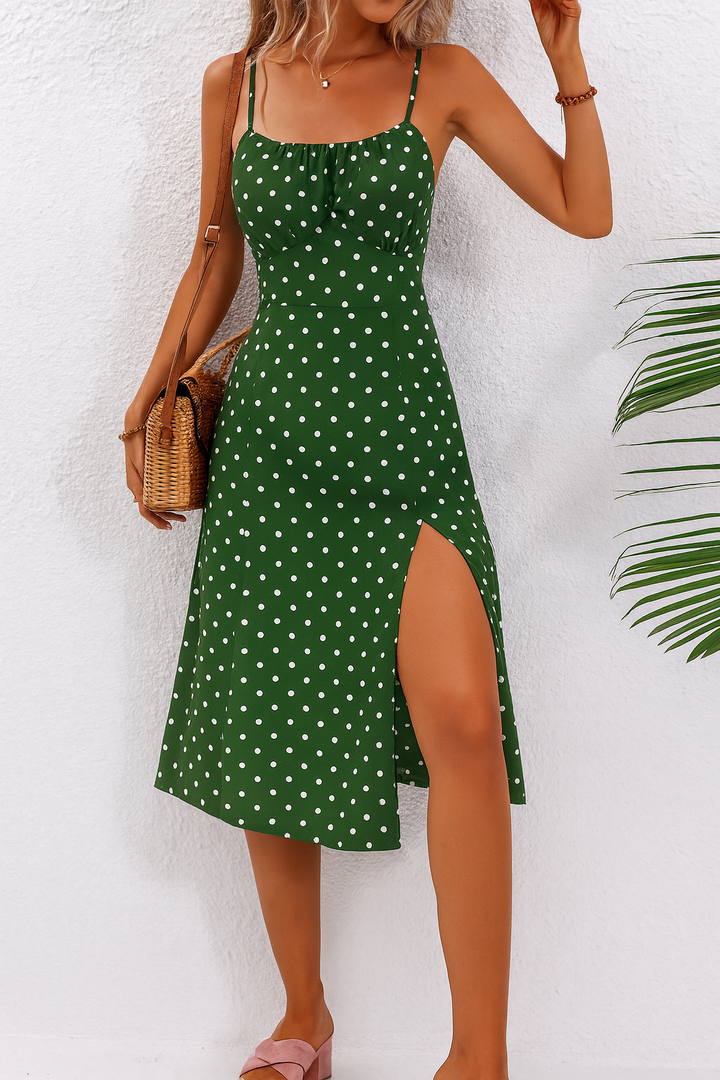 Green polka dot midi dress paired with woven crossbody bag