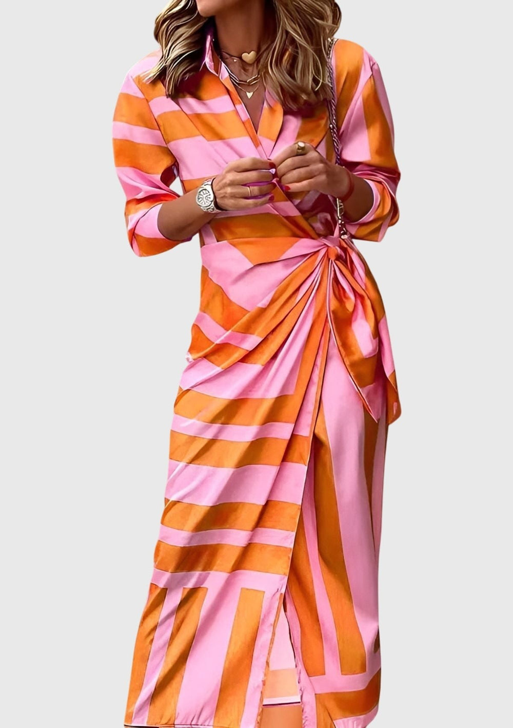 pink and orange wrap dress featuring long sleeves and side tie detail