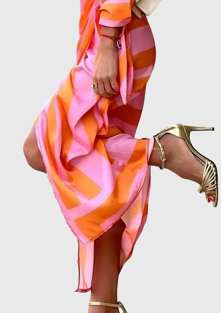 close-up of pink and orange striped wrap dress with flowing skirt slit
