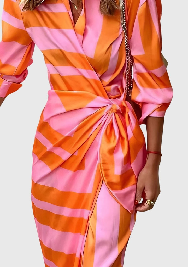 detail shot of pink and orange wrap dress waist tie and draped fabric