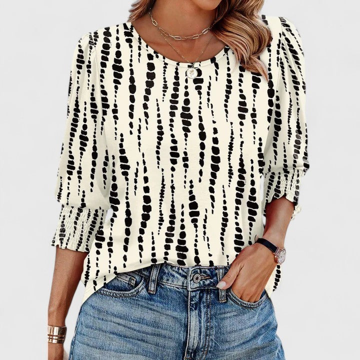 ivory abstract print top with black stripes and smocked cuffs