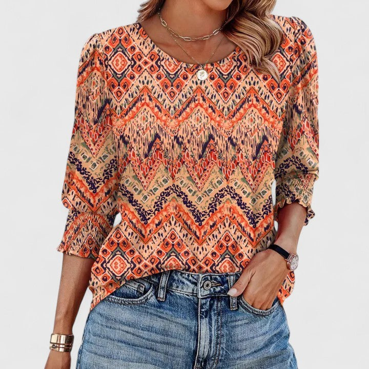 orange tribal print top with smocked cuff sleeves