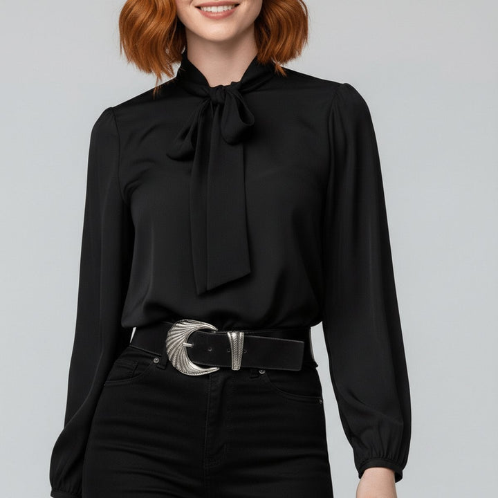 Black bow-tie neck blouse with puffy sleeves paired with black skinny jeans