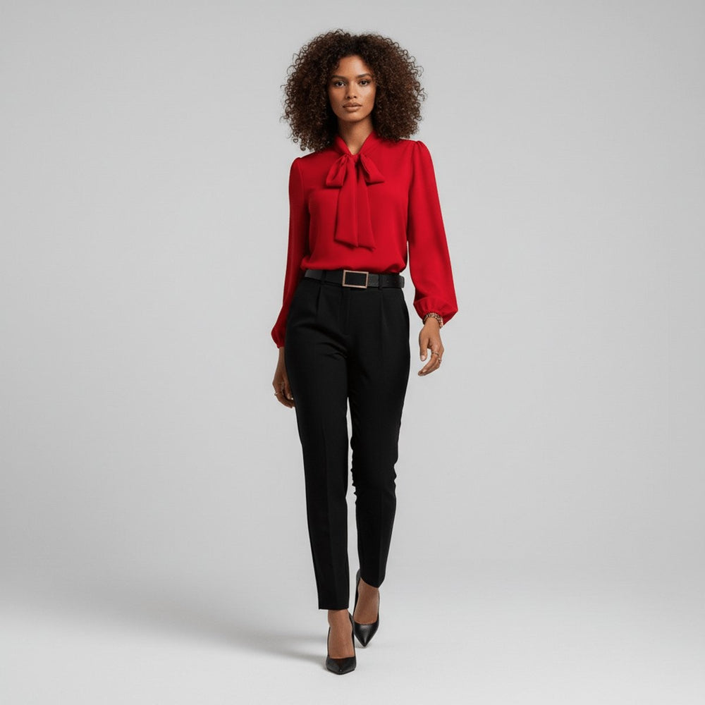 Model wearing red relaxed-fit blouse with tie neck and black tapered pants