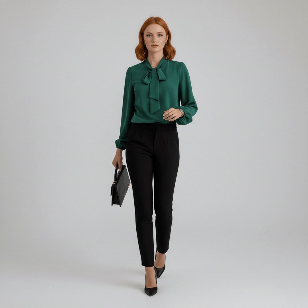 Full-length look of green tie-neck blouse styled with black pants and handbag