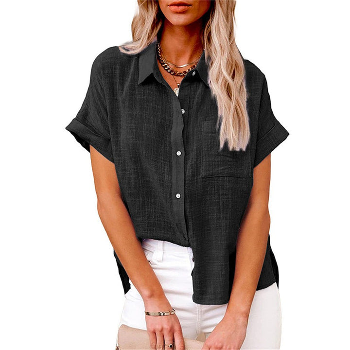 Black linen-style shirt with front pocket, worn over white jeans