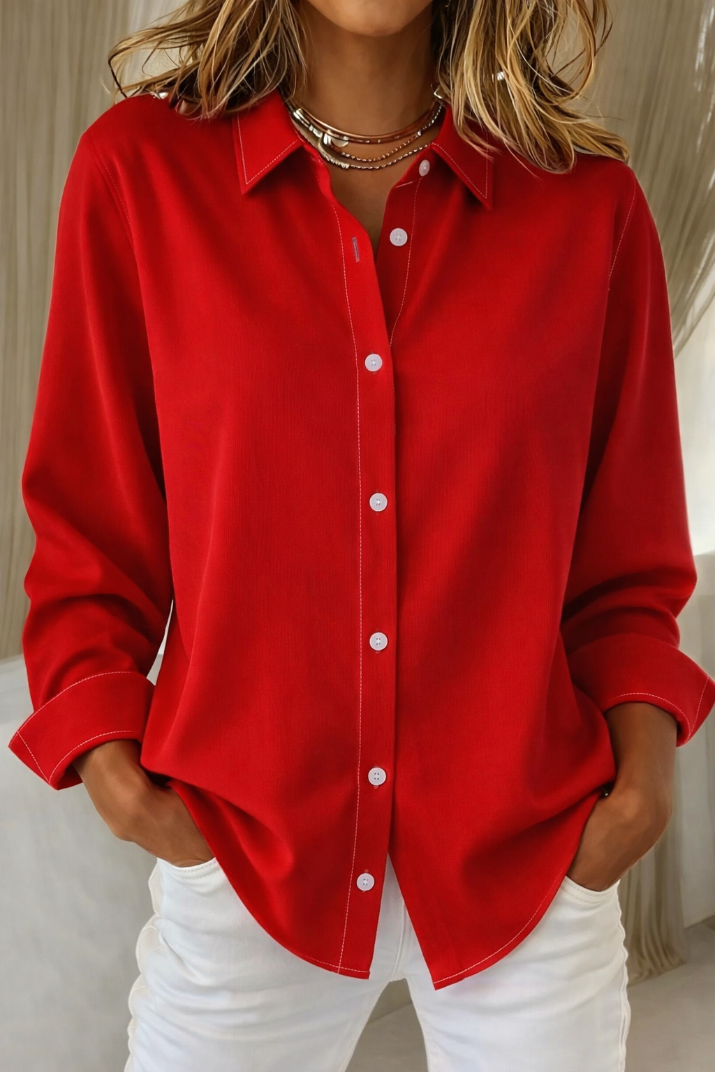 Red collared button-down blouse with white topstitching and folded cuffs