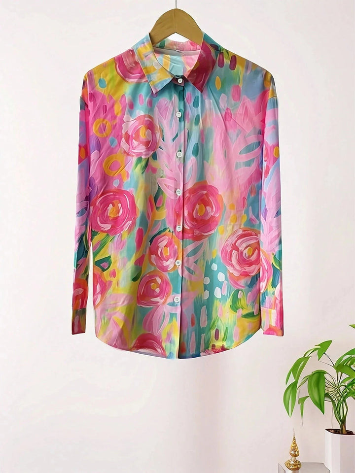 flat lay of colorful rose print button-down blouse on hanger