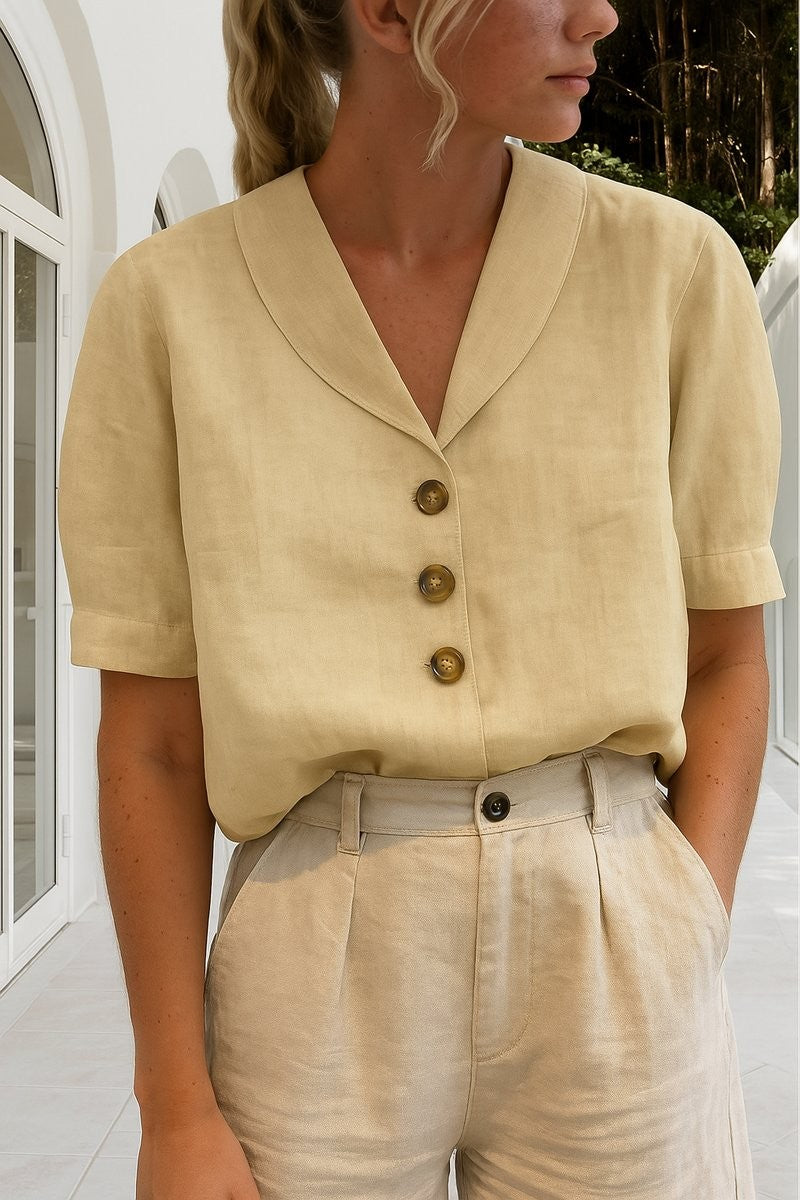 Pale yellow relaxed-fit blouse featuring tortoiseshell buttons and collared neckline