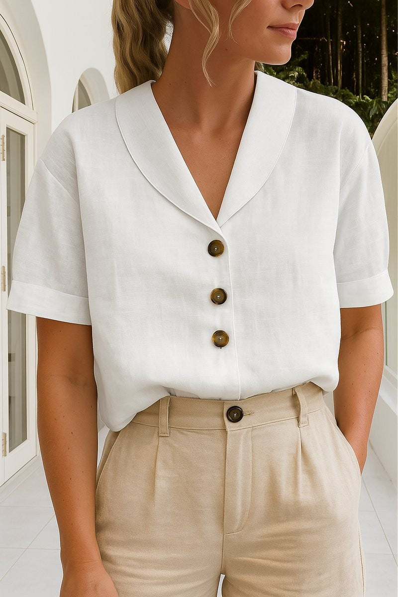 white linen button-front blouse with shawl collar and short sleeves, paired with beige trousers