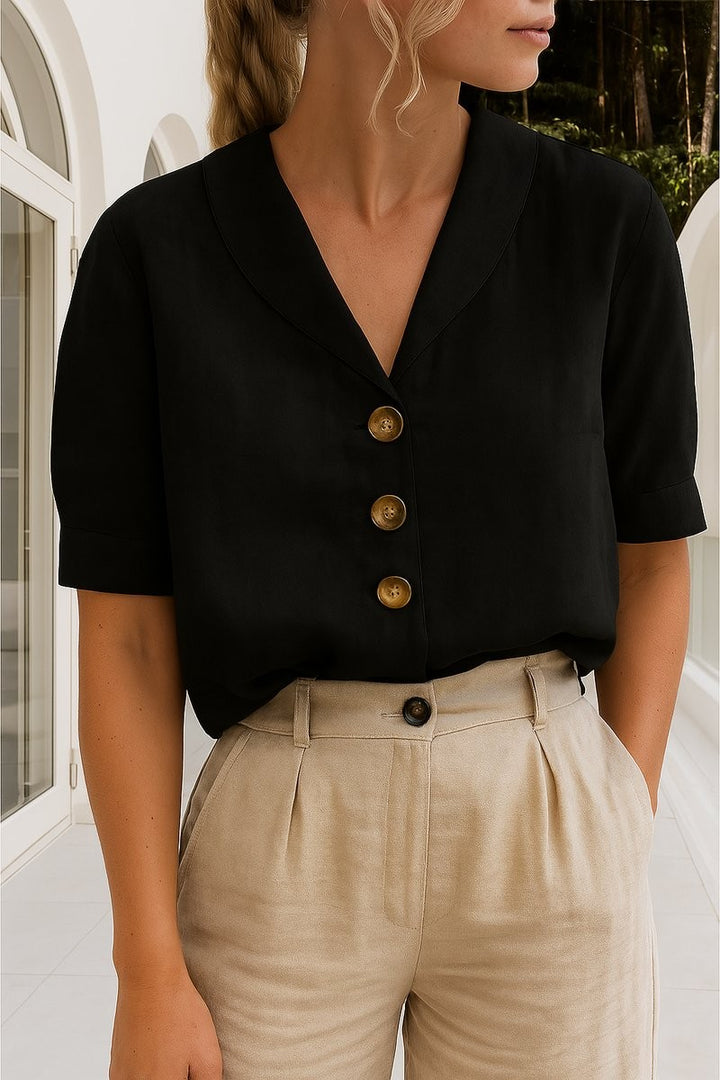 black short-sleeve collared blouse with button-front detail and beige trousers
