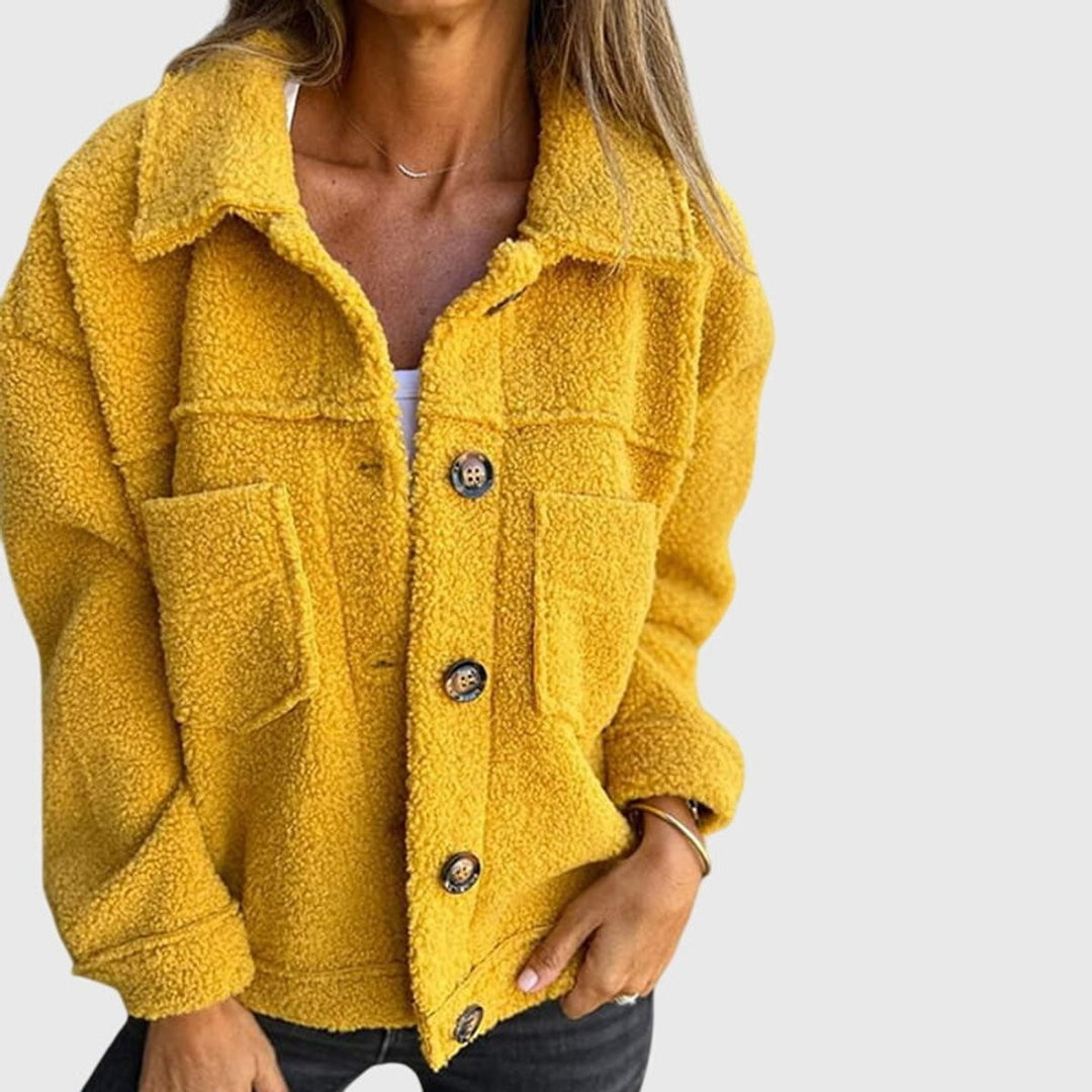 Mustard yellow teddy fleece jacket featuring button fastening and front pockets