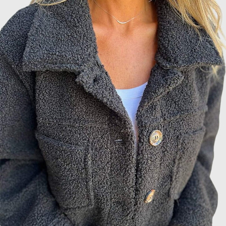 Close-up of charcoal sherpa fleece jacket collar and front buttons