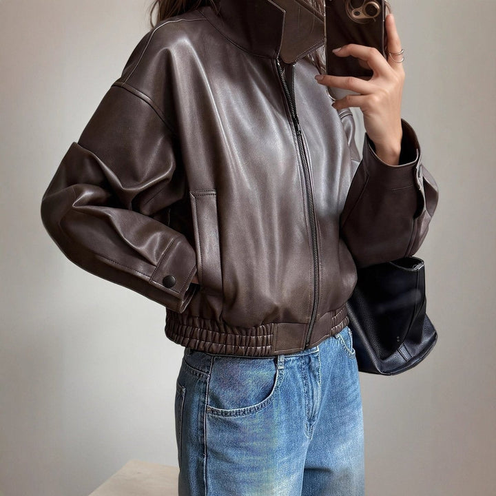 Dark brown faux leather bomber jacket with zip-up front and stand collar