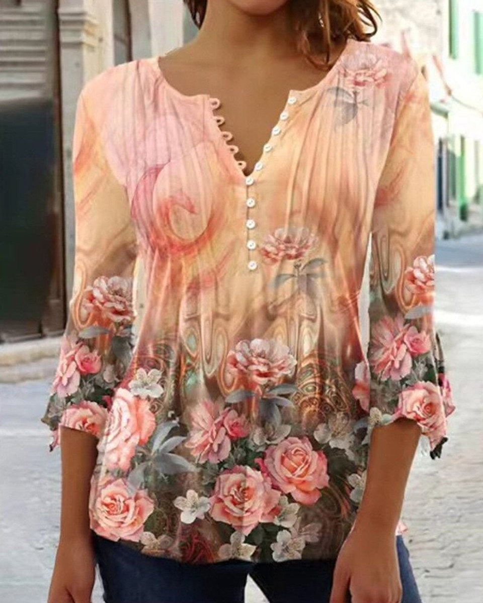 Pink and tan floral henley blouse with bell sleeves and button neckline