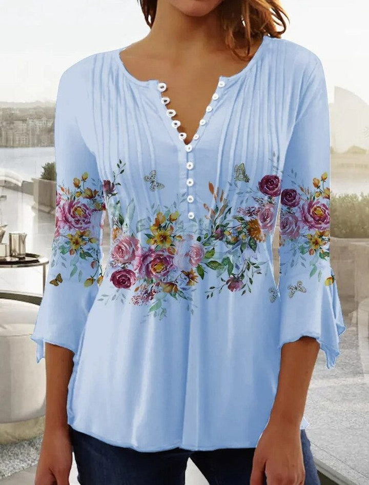 Light blue floral henley top with bell sleeves and button placket