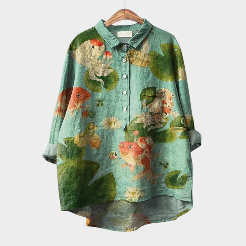 Seafoam green blouse with whimsical koi fish and lily pad print, high-low hem