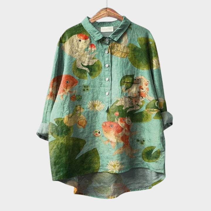 Seafoam green blouse with whimsical koi fish and lily pad print, high-low hem