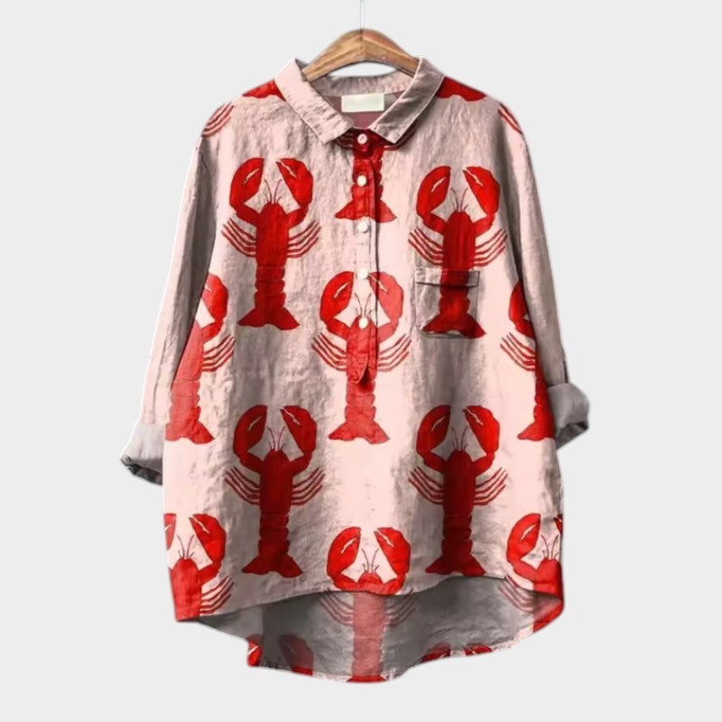 Blush pink high-low blouse featuring an allover red lobster print, button-front collar