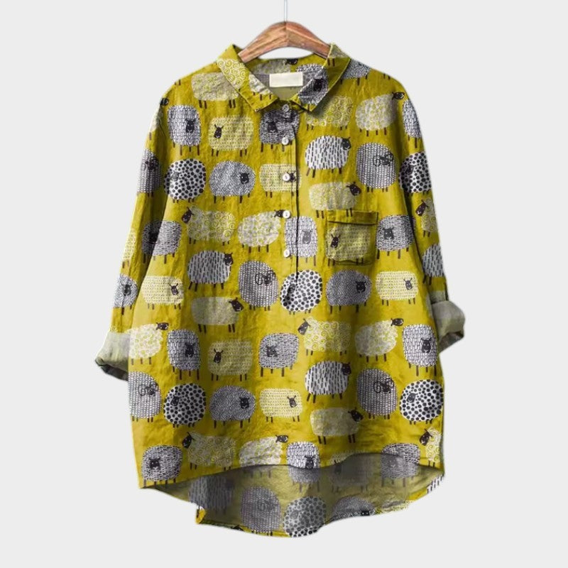 Mustard yellow high-low blouse covered in a whimsical cartoon sheep print