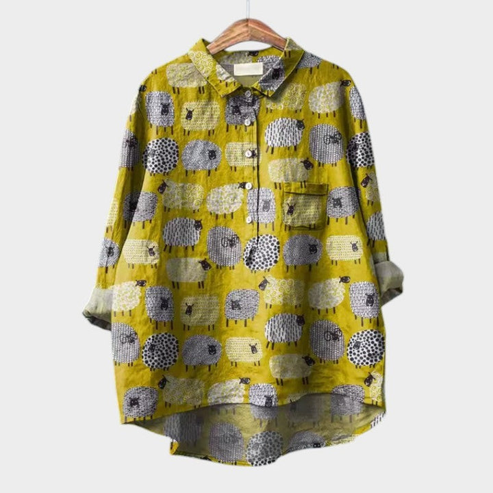 Mustard yellow high-low blouse covered in a whimsical cartoon sheep print