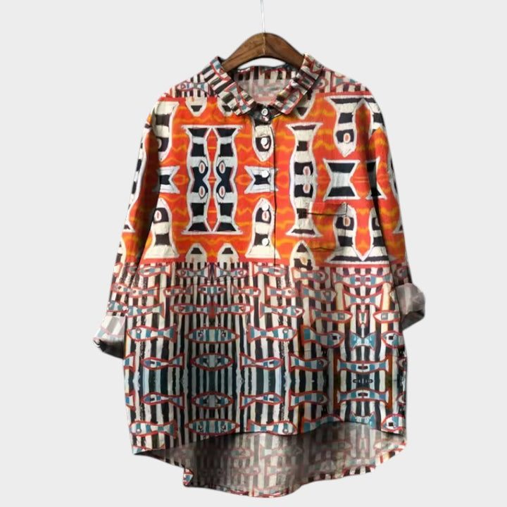 Orange and black geometric print high-low blouse with tribal-inspired pattern blocks