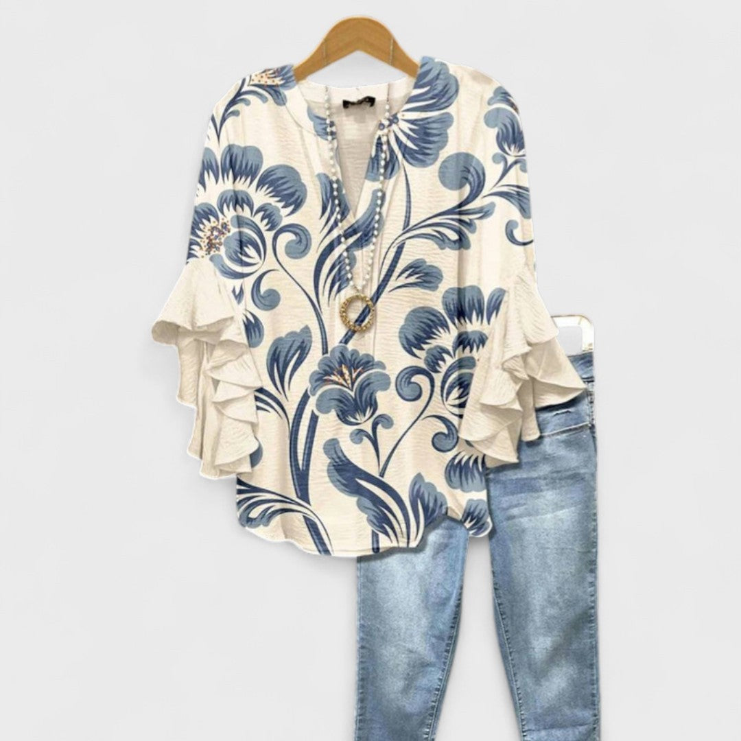 Cream blouse with blue floral print and ruffled bell sleeves