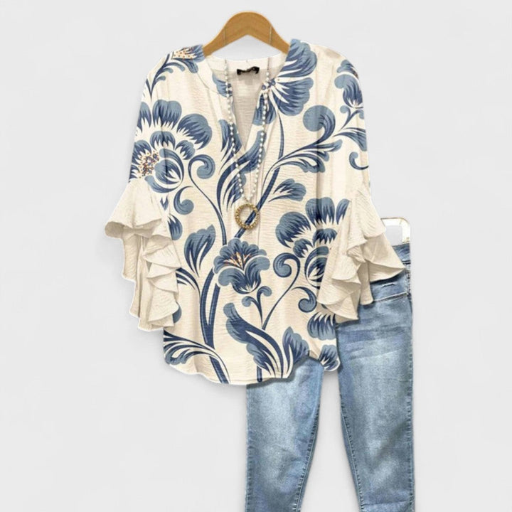 Cream blouse with blue floral print and ruffled bell sleeves