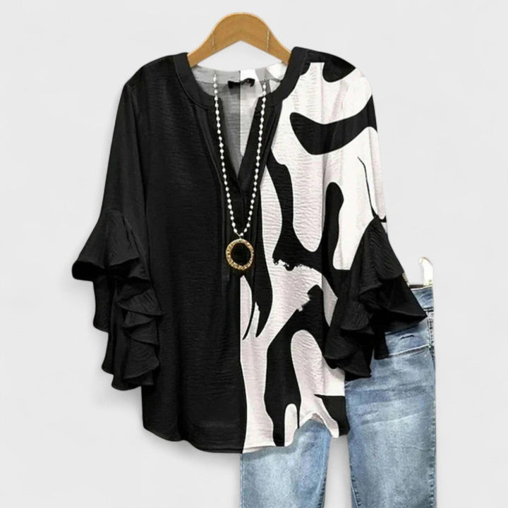 Black and white abstract print blouse with ruffled bell sleeves