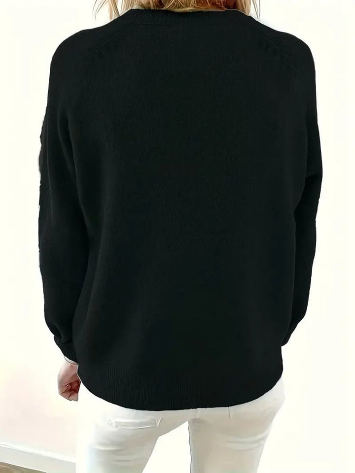 Back view of black knit jumper showing relaxed raglan-sleeve fit