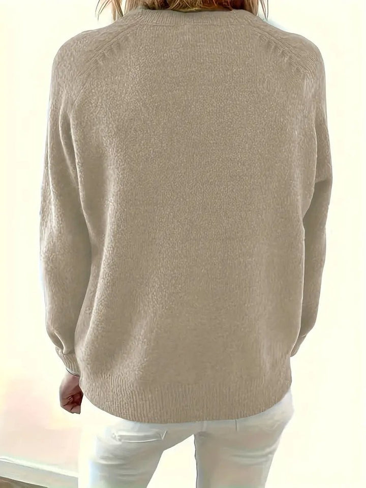 Back view of beige knit jumper highlighting ribbed hem and cuffs
