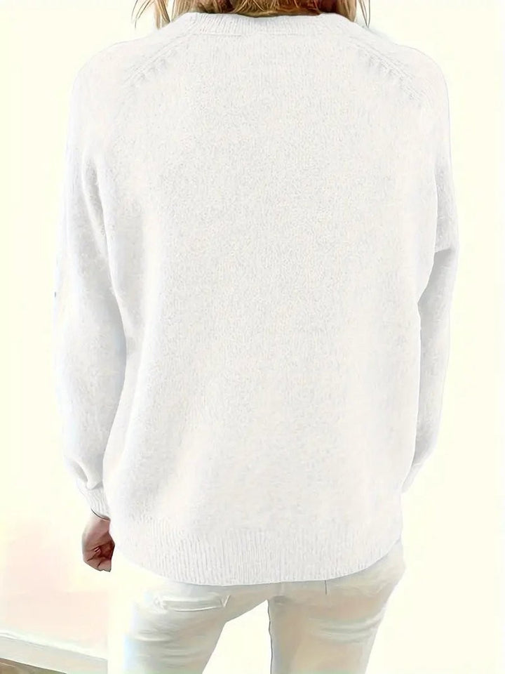 Back view of white knit jumper showing loose raglan-sleeve silhouette