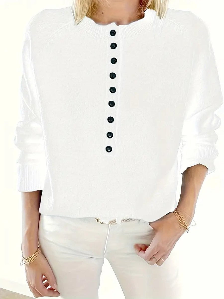 Close-up of white half-button knit jumper with ribbed neckline