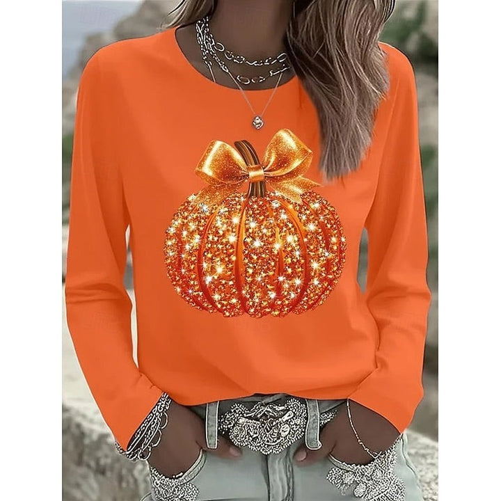 orange long-sleeve top with sparkling glitter pumpkin and bow graphic