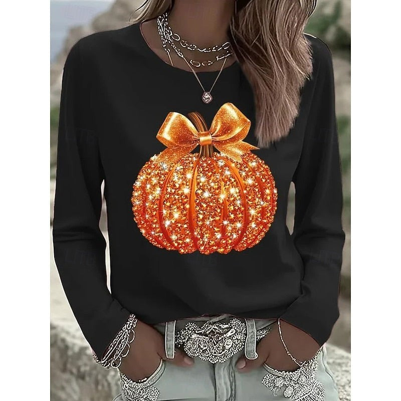 black long-sleeve crew-neck top featuring a glittery orange pumpkin design