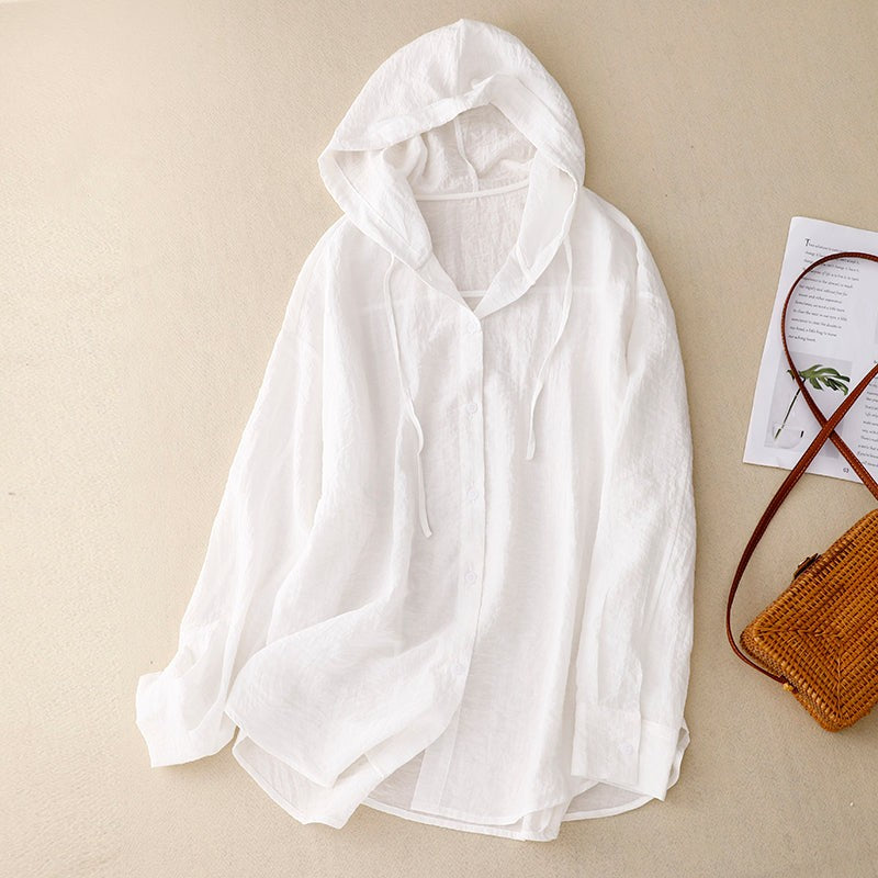White lightweight linen hooded button-up shirt laid flat with long sleeves