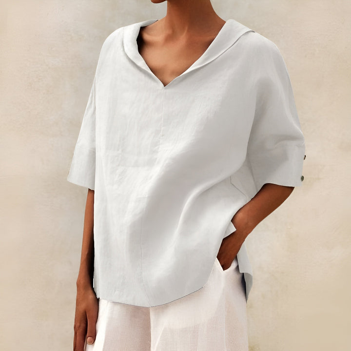 White linen-blend blouse with V-neck collar and oversized short sleeves
