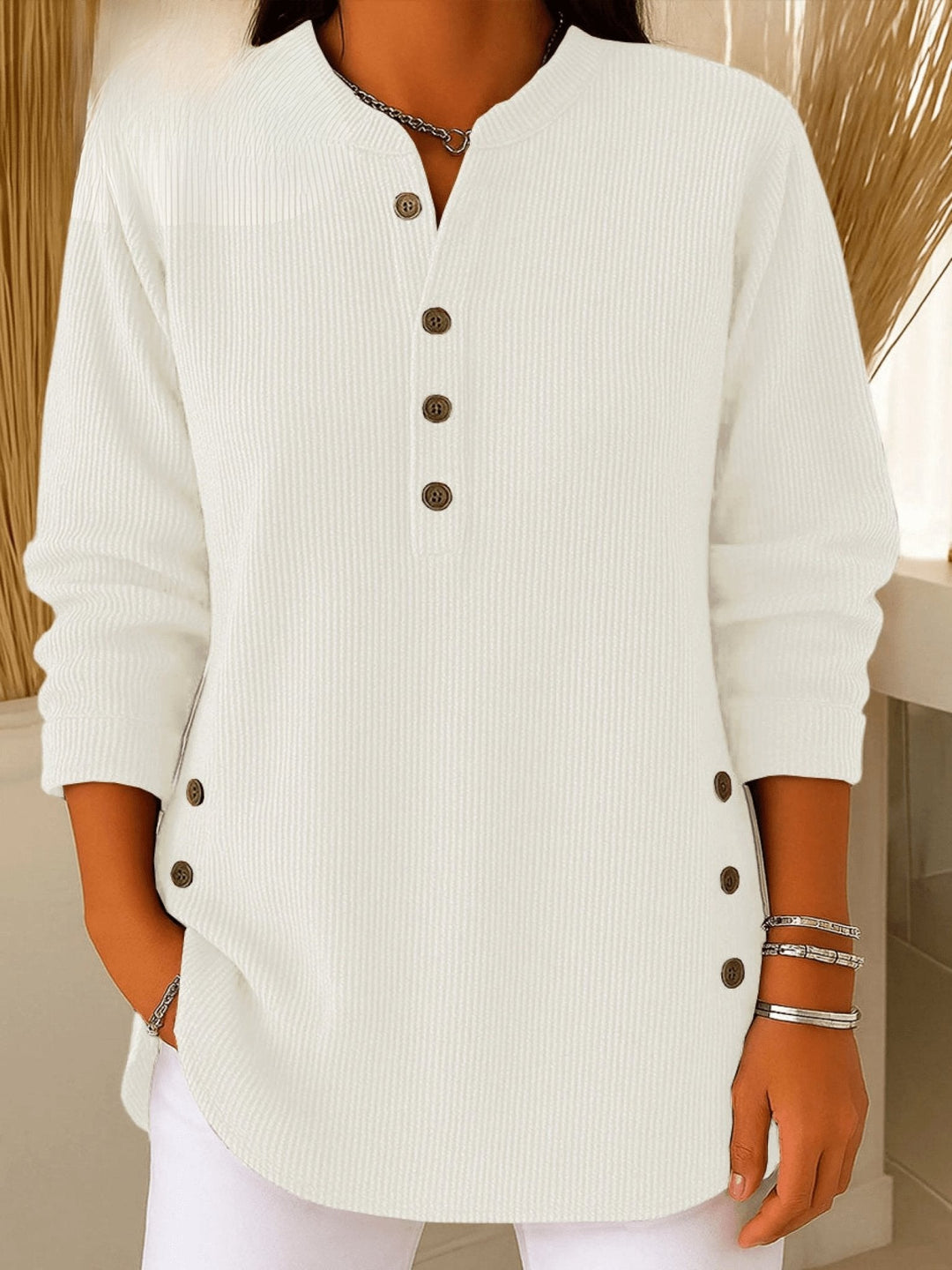 White ribbed knit henley tunic featuring button placket and curved hem