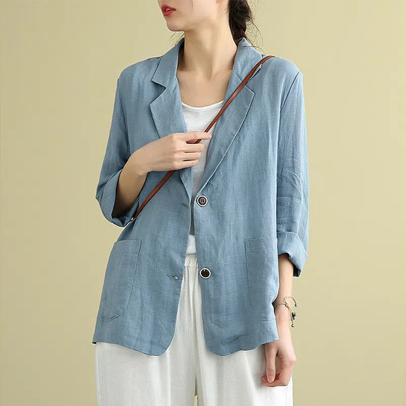 Dusty blue linen blazer with notched lapel and patch pockets, worn open