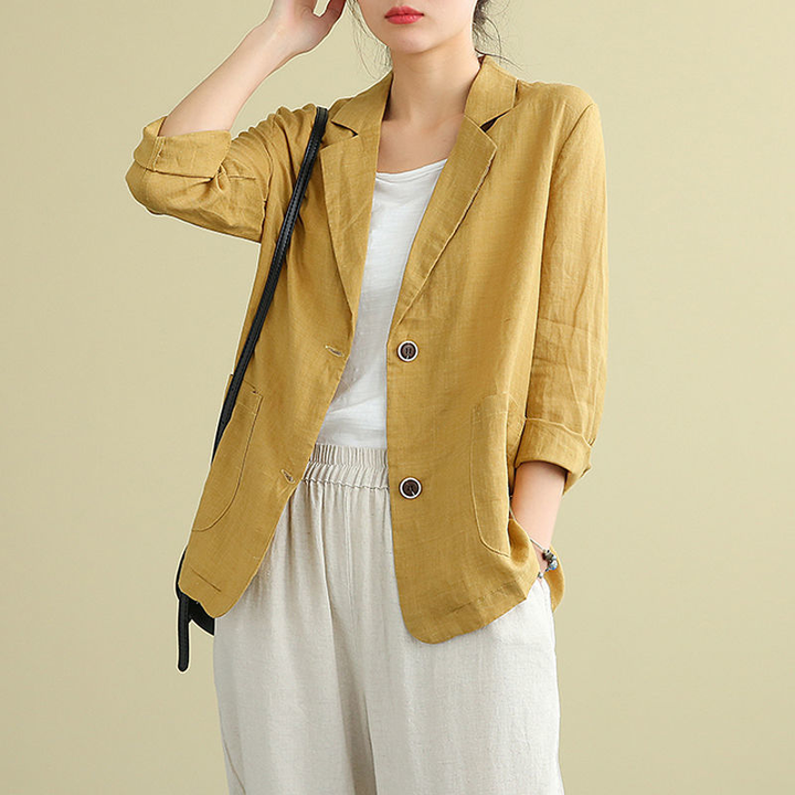 Mustard yellow linen blazer featuring tailored button fastening and front pockets