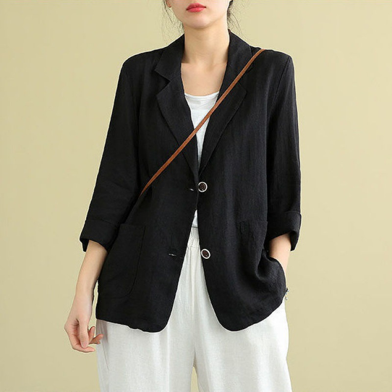 Black linen blazer with relaxed fit, rolled sleeves and patch pockets